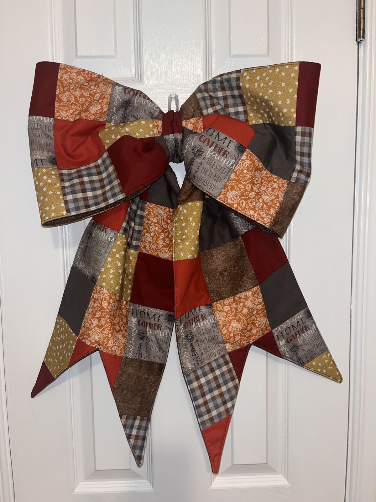 Finished patchwork fabric bow on a door