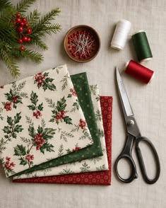 Christmas holly fabrics, thread and scissors