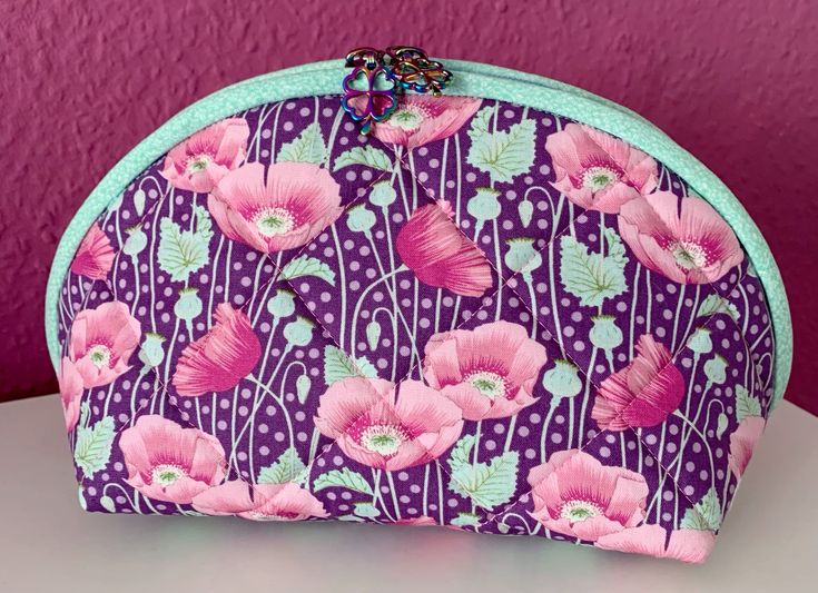 Finished quilted clamshell pouch in purple poppy fabric