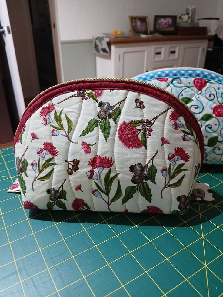 Two finished quilted clamshell pouches