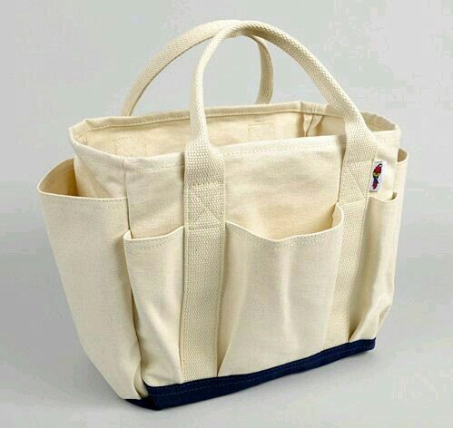 Finished cream canvas tote with outside pockets